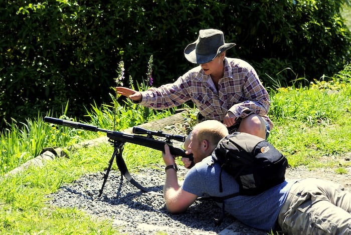 Man learning to shoot a gun.