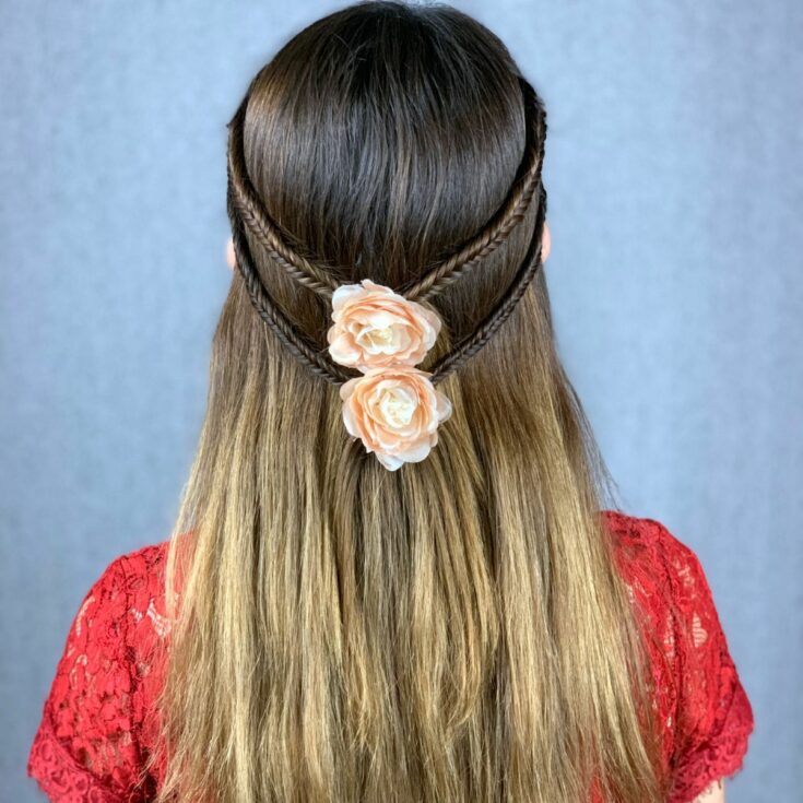 braided hair half up with coral flower clips on back of head