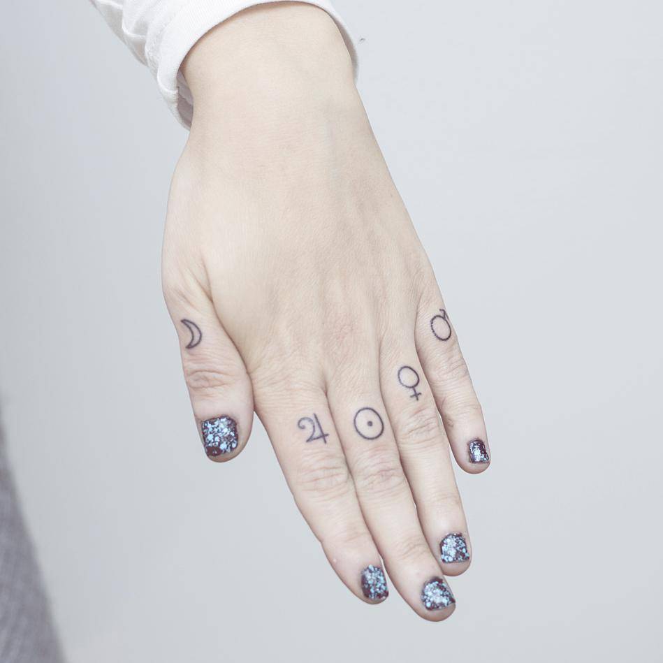 Hand Poked Planet Symbol Tattoos On The Knuckles. 949_x_949_jpg
