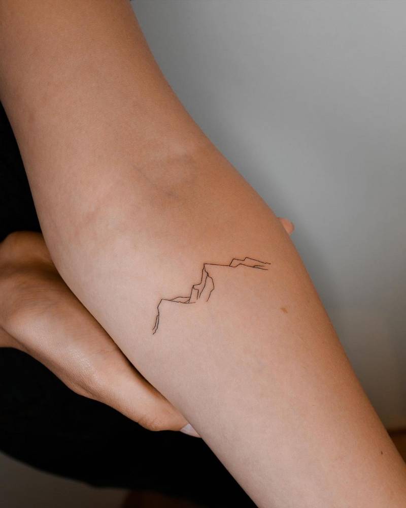 Minimalist Mountain Tattoo On The Inner Forearm.