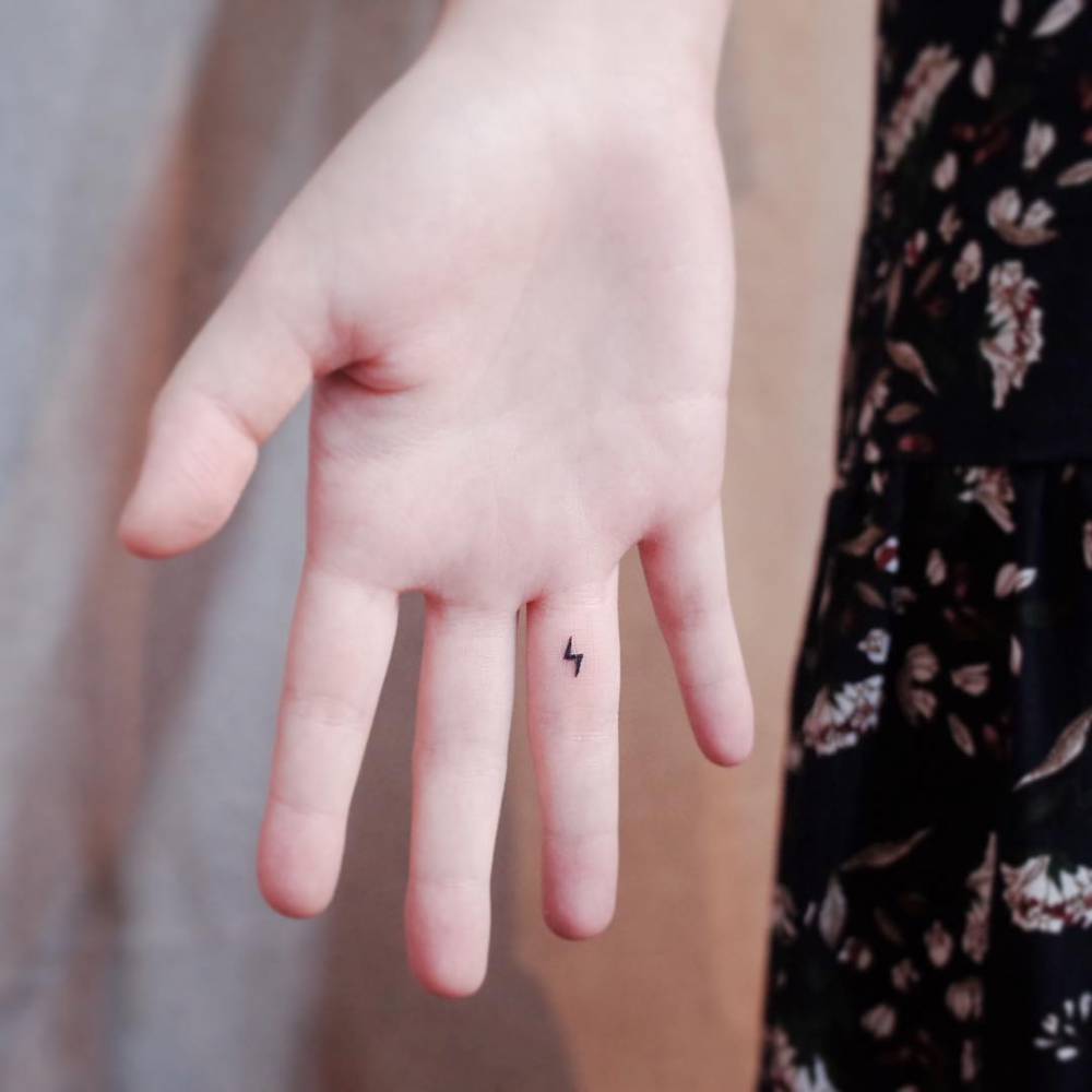 Tiny Bolt Tattoo On The Inner Finger. 1000_x_1000_jpg