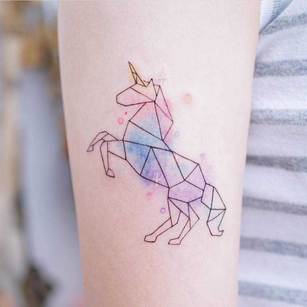 Watercolor Unicorn Tattoo On The Upper Arm.