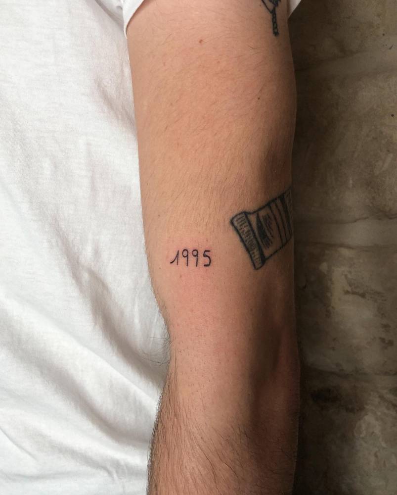 1995" Lettering Tattoo Located On The Upper Arm. 1000_x_803_jpg