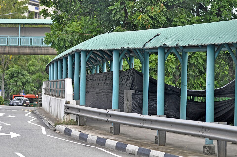 Covered pedestrian walkway beside a road near Buona Vista MRT station in Singapore