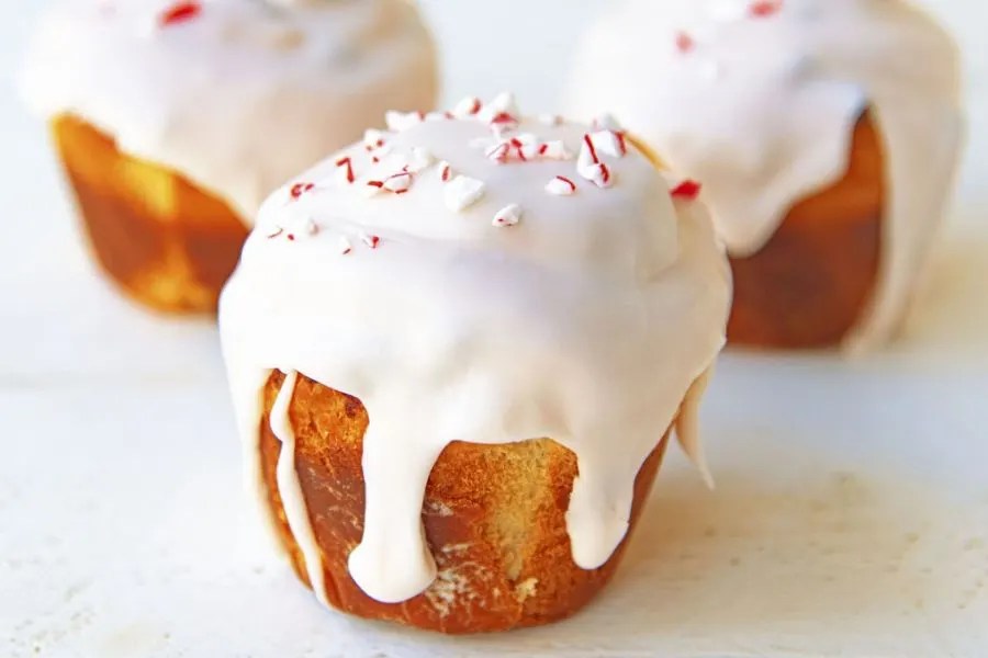 A cinnamon roll topped with crushed candy canes.