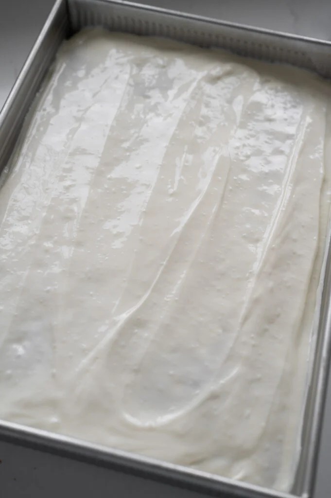 A cake with a white topping.