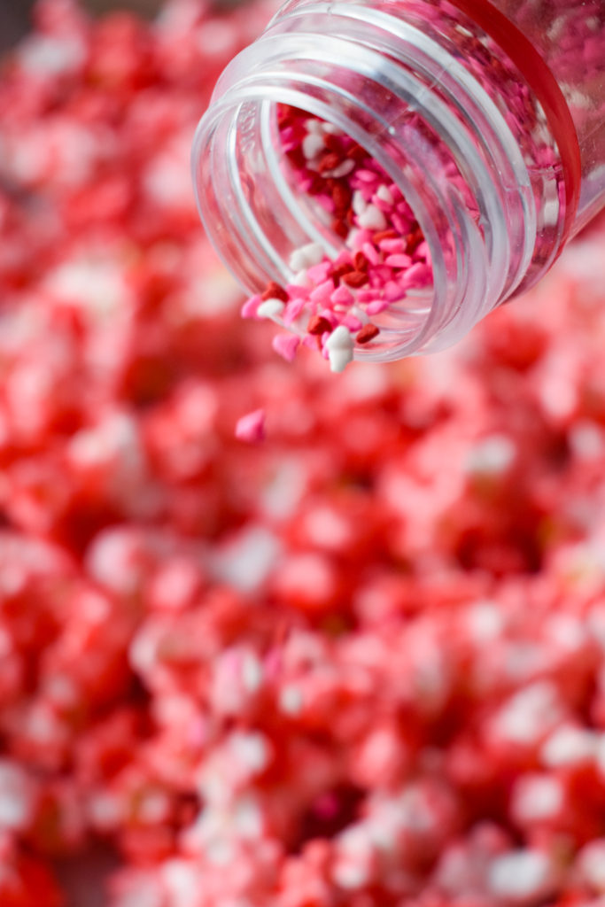 Sprinkles going onto the cinnamon popcorn