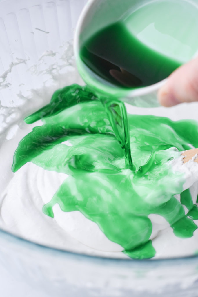 creme de menthe being poured into the melted marshmallows