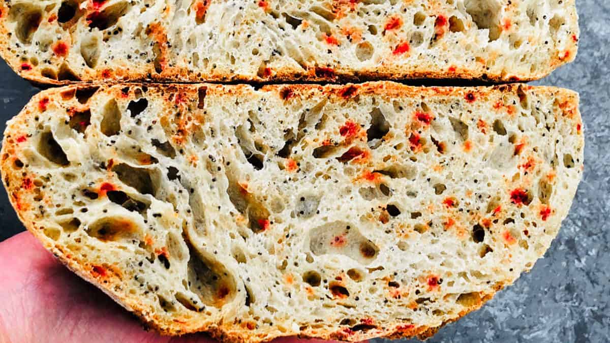 Sourdough beetroot bread cut and placed on a grey surface.