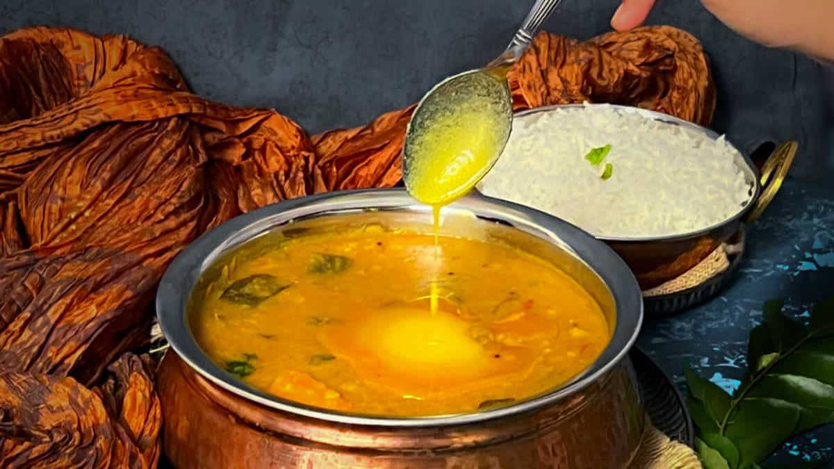 Smbar with ghee being poured from top.