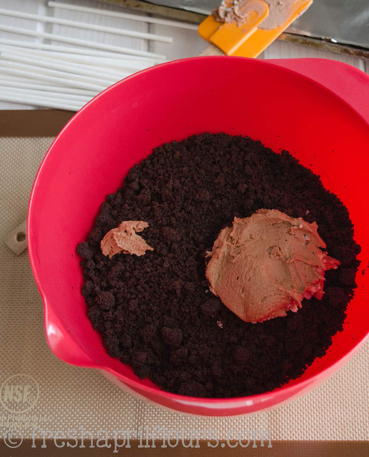 frosting in a bowl of crumbled cake 