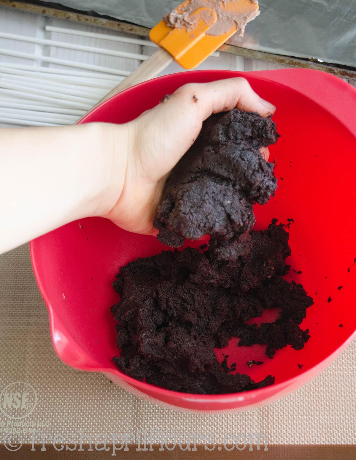 hand holding cake mixture for cake pops