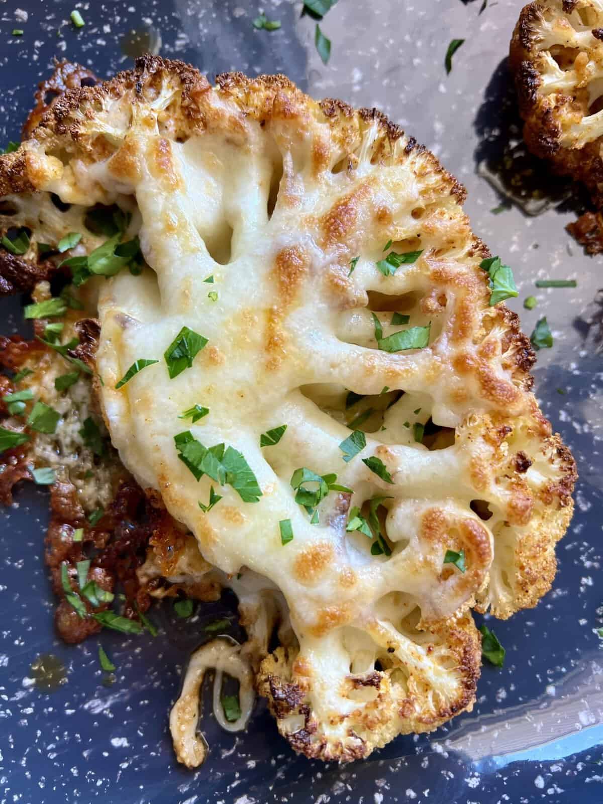 Cheesy Cauliflower Steaks - Hungry Happens Cauliflower steaks pan fried