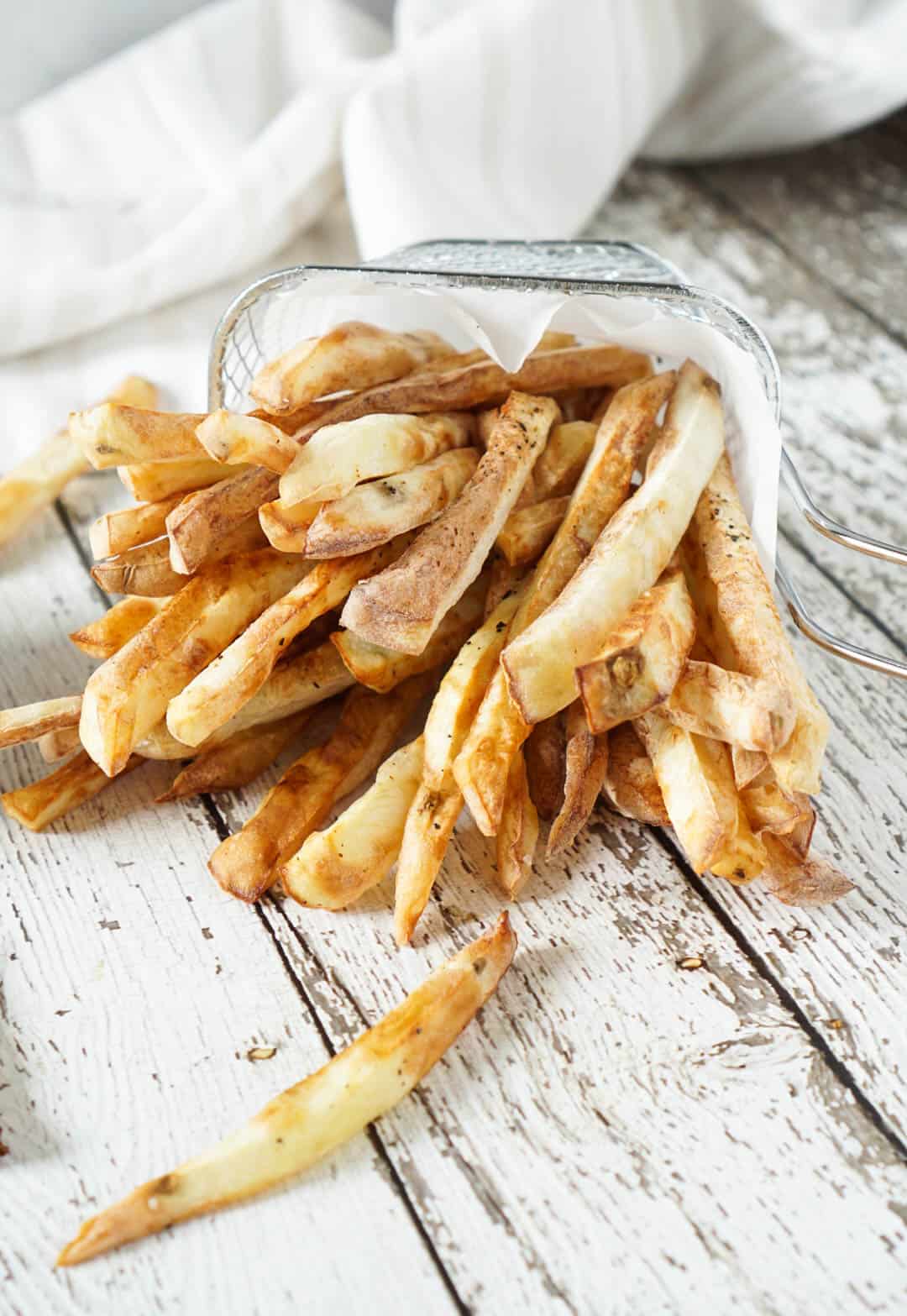 french fries spilling out of a fry basket