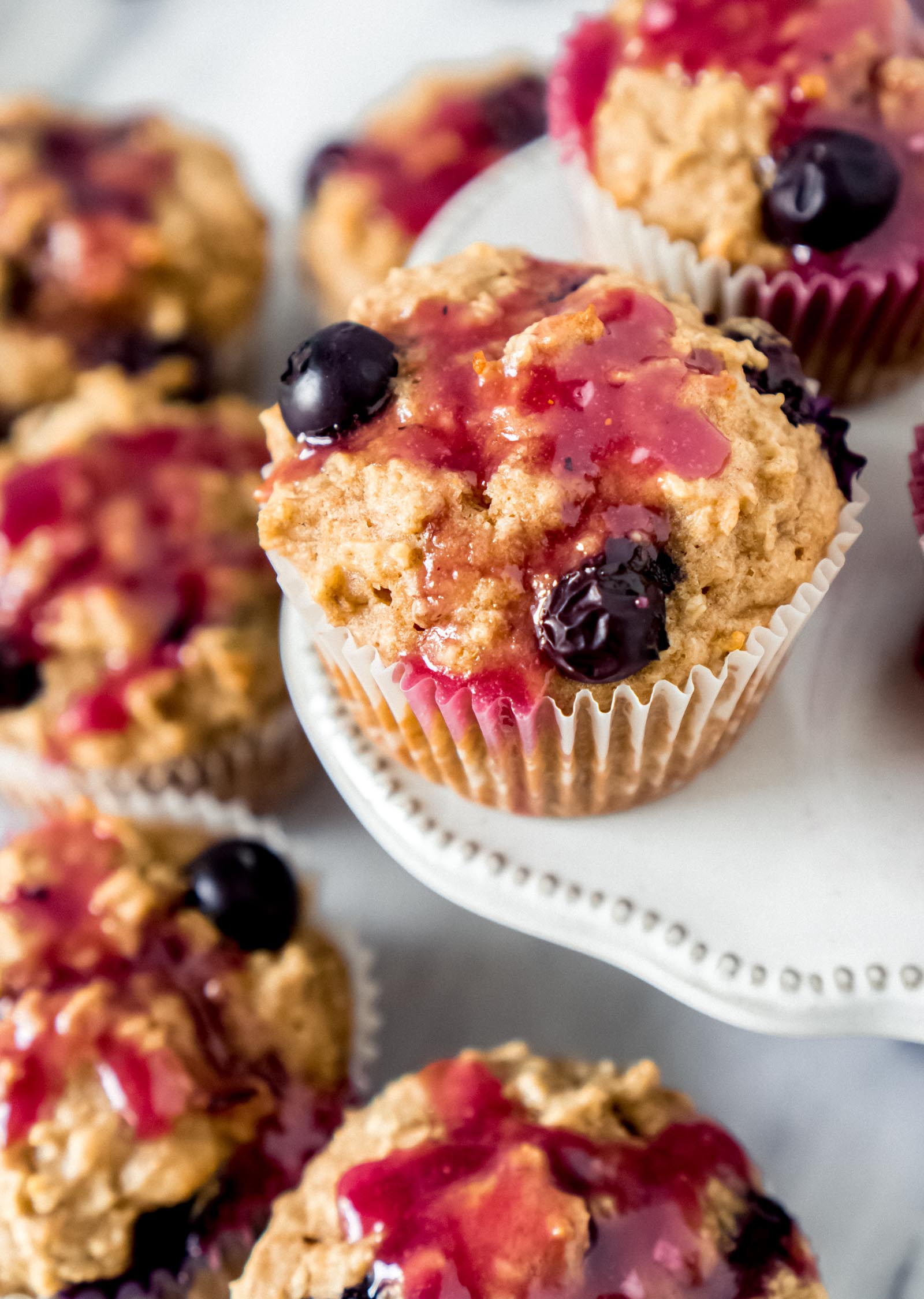 lemon blueberry muffins on a white cake stand