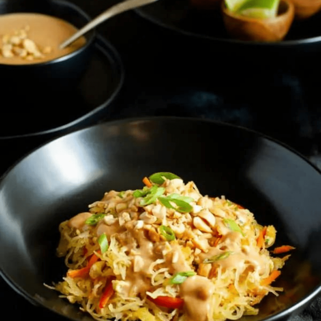 spaghetti squash pad thai in a black bowl