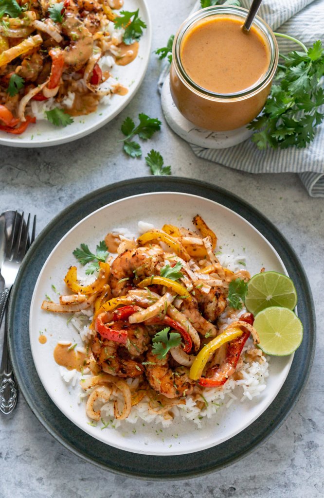 two plates with air fryer shrimp and peppers over rice