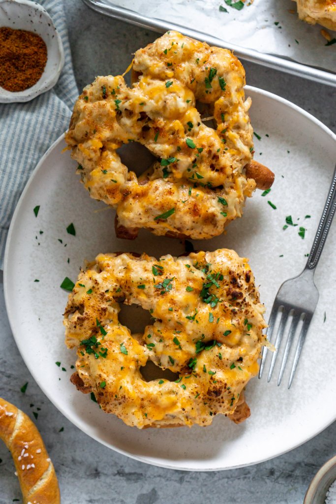two crab pretzels on a white plate with a fork