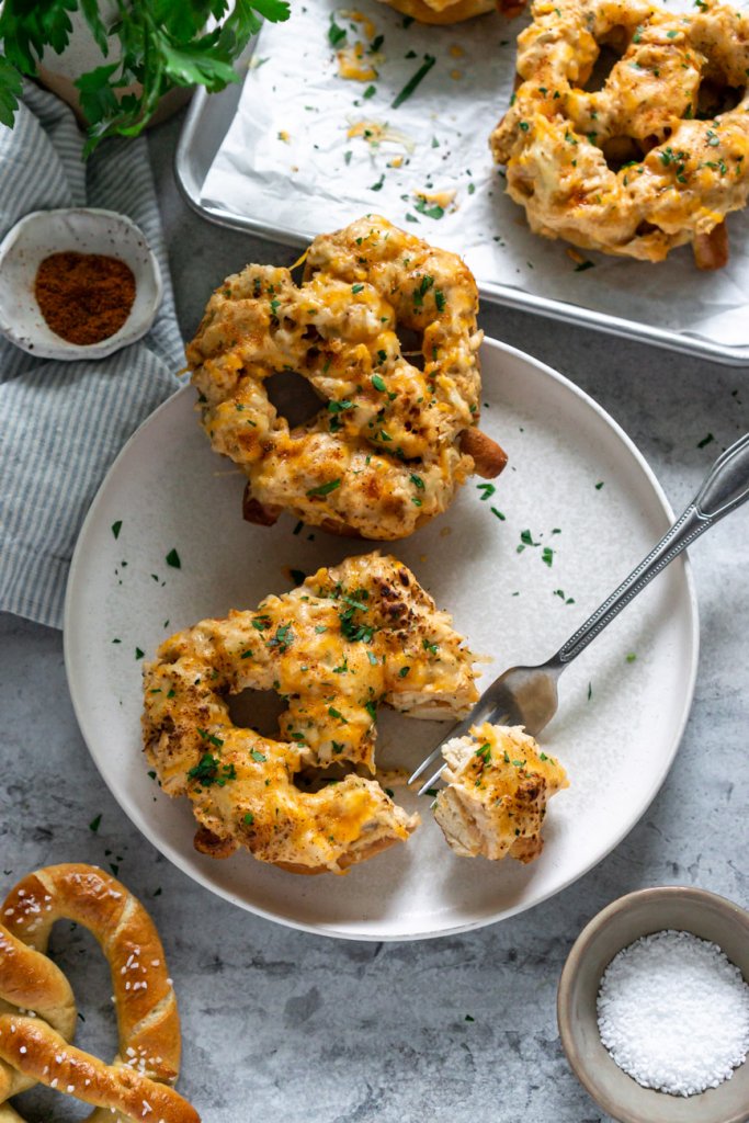 fork with a bite of crab pretzel on a white plate