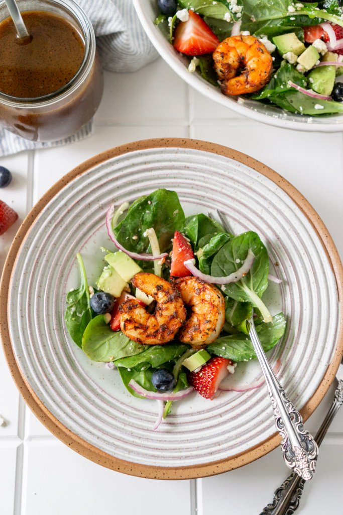 salad on a white plate with shrimp