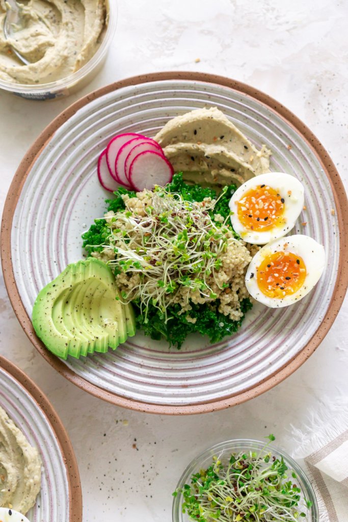breakfast hummus bowl with eggs and avocado