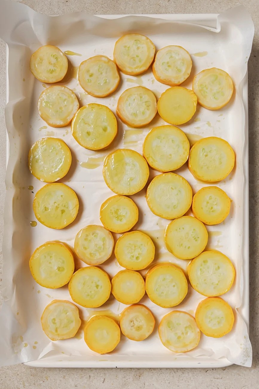 Yellow squash on a prepped baking sheet in a single layer.