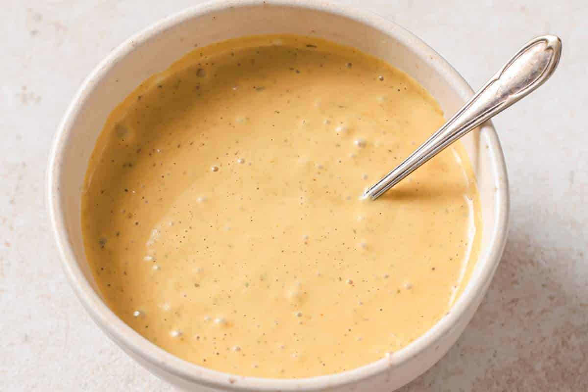 Stirring Chick-fil-A sauce in a small white bowl.
