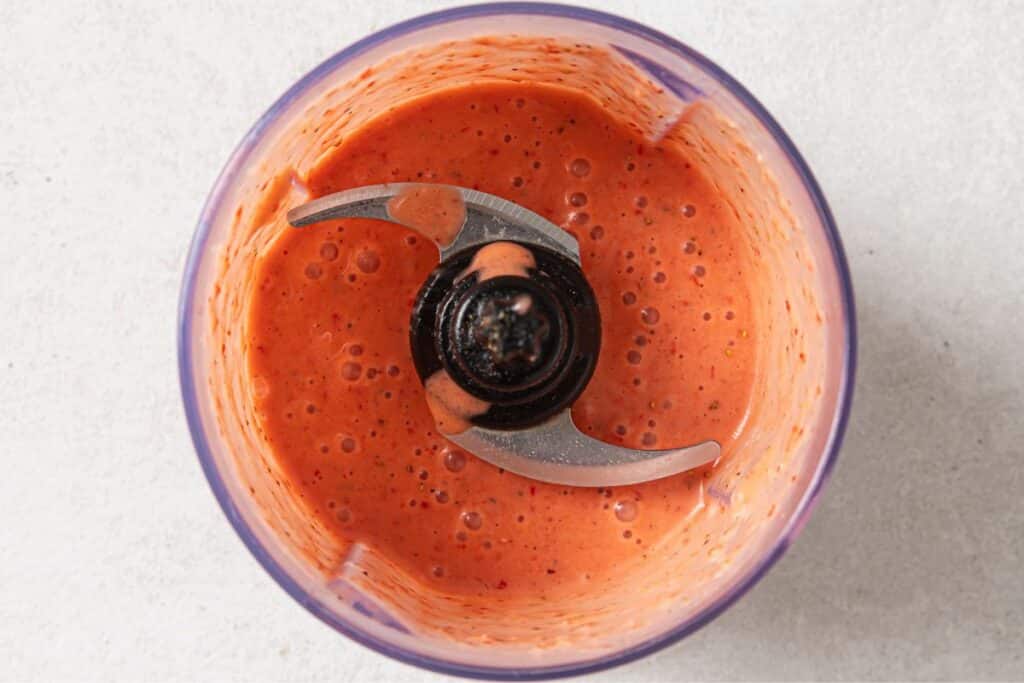 Strawberry vinaigrette in a food processor all blended into a smooth dressing.