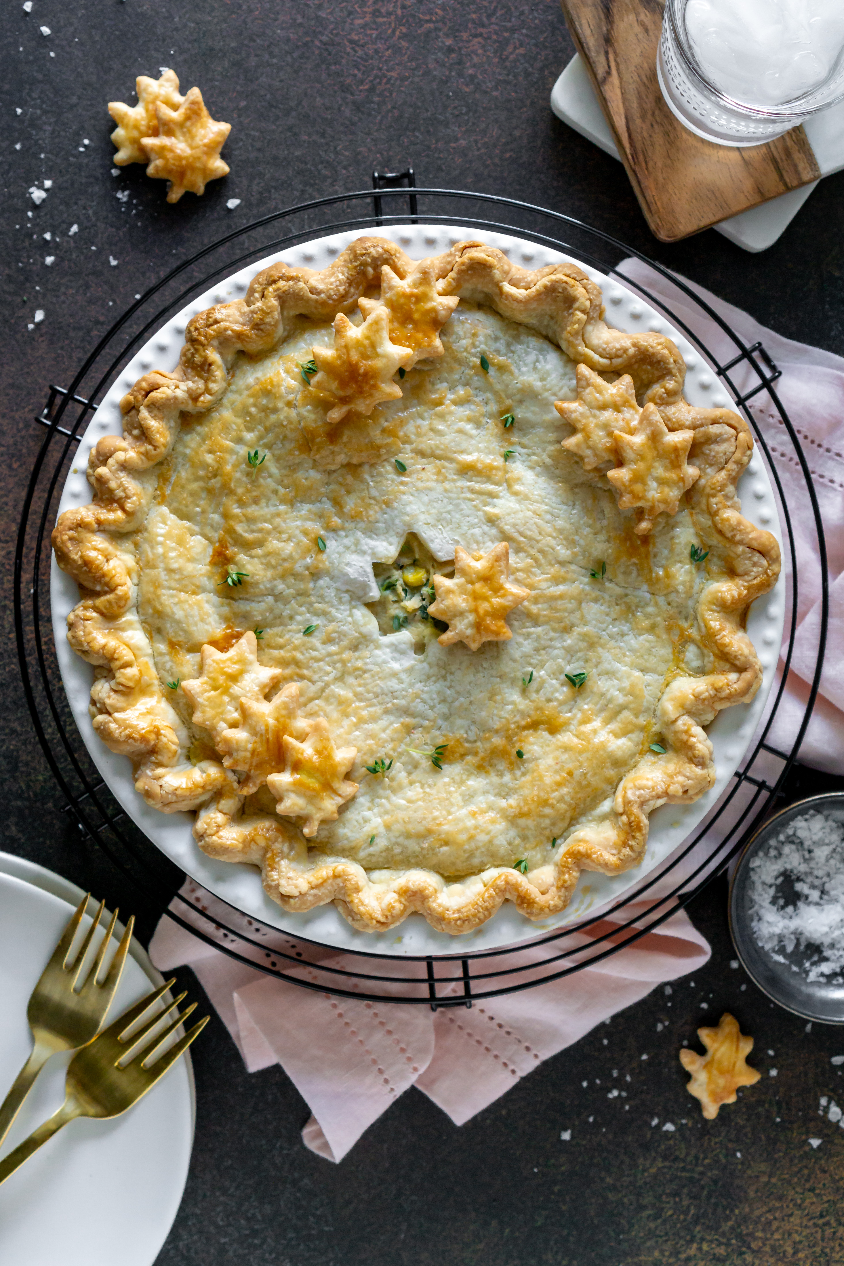 chicken pot pie with gold forks and a pink napkin