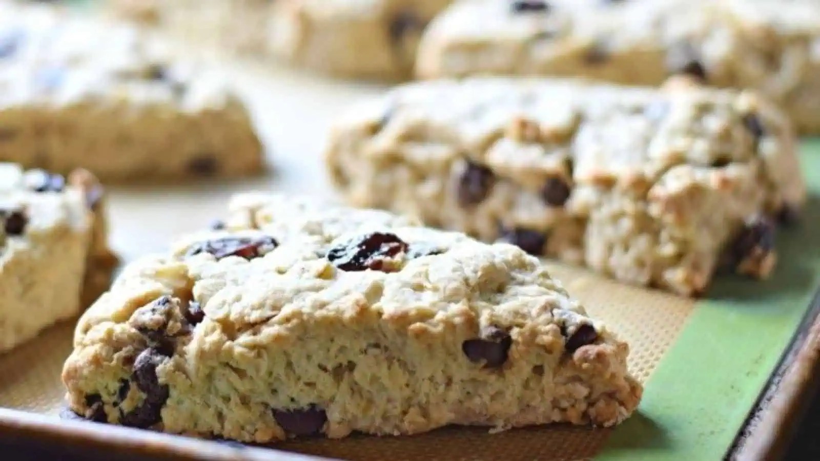 Cherry chip scones on a baking sheet.