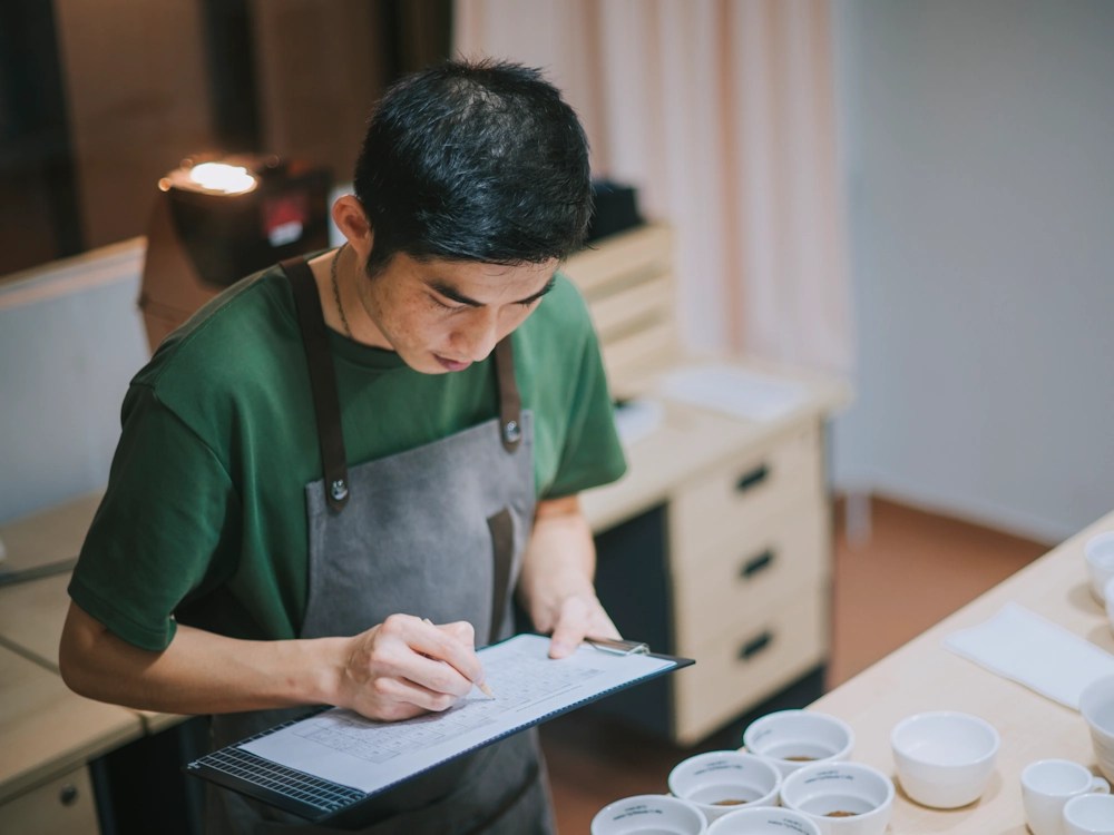 - Healthy Brew Hub A Q grader scores coffees during a cupping.