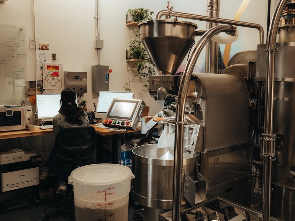 healthy brew hub a person roasts coffee at subtext coffee in canada using a loring machine