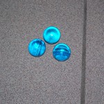Three blue bath oil beads