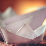 White paperboats sunset