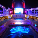 Pools and deck at night - Disney Dream