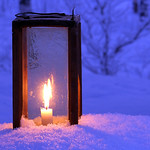 Close-up of a lit lantern in the snow