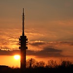 The television tower of city goes at sunset