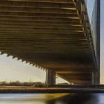 Underside of Indian River Inlet Bridge Illuminated By Reflected Early Morning Sun