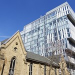 Condo towers over church