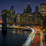 Classic view of traffic on the FDR Drive with Lower Manhattan and the Brooklyn Bridge at sunset, New York City.