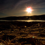 Alone on a beach watching the sun go down.