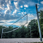 volleyball net set up in the woods on sand lot