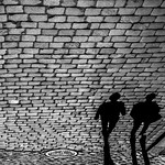 Two shadows at cobblestone