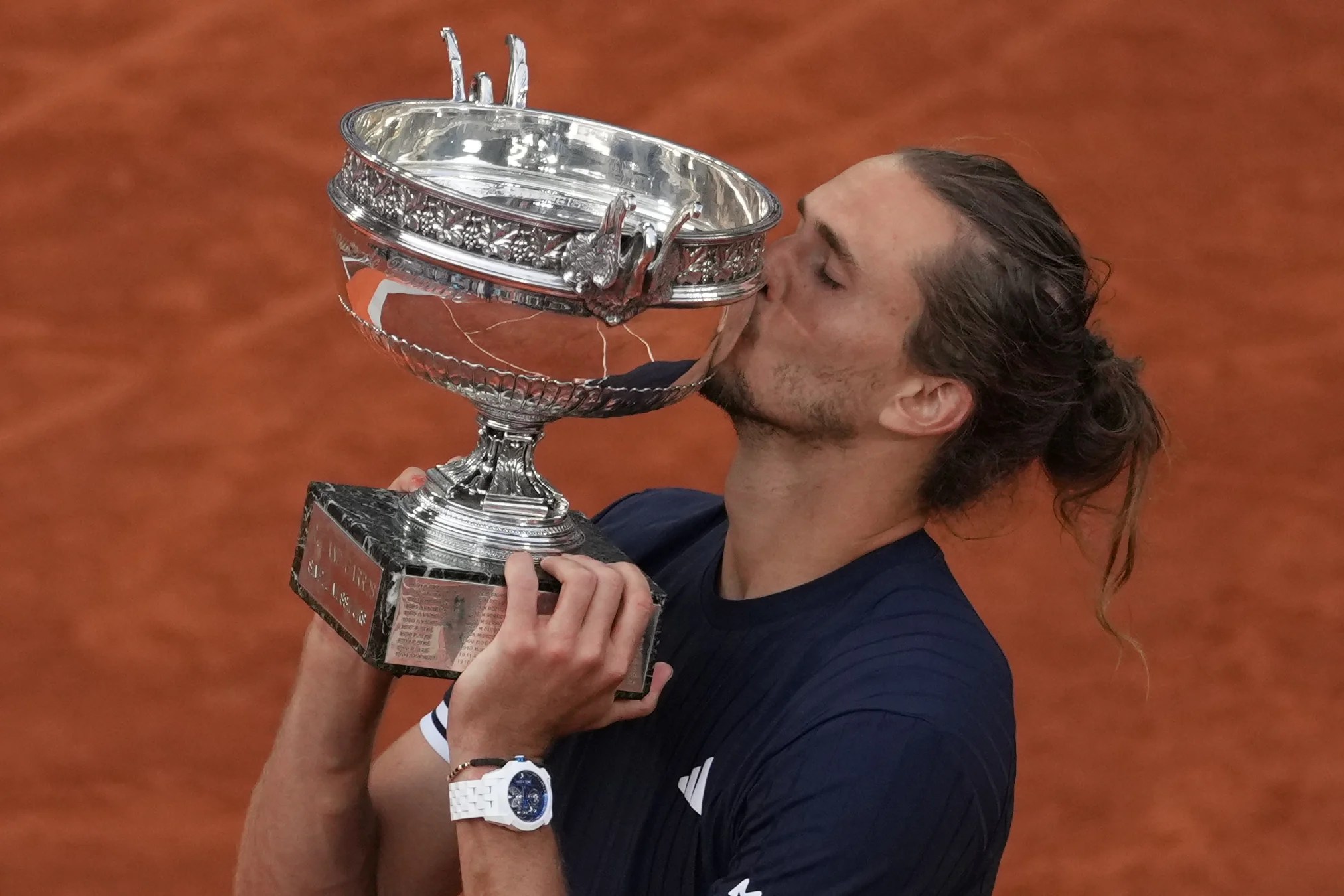 rewrite this title Zverev conquers demons and outlasts Cobolli to win French Open for first major title