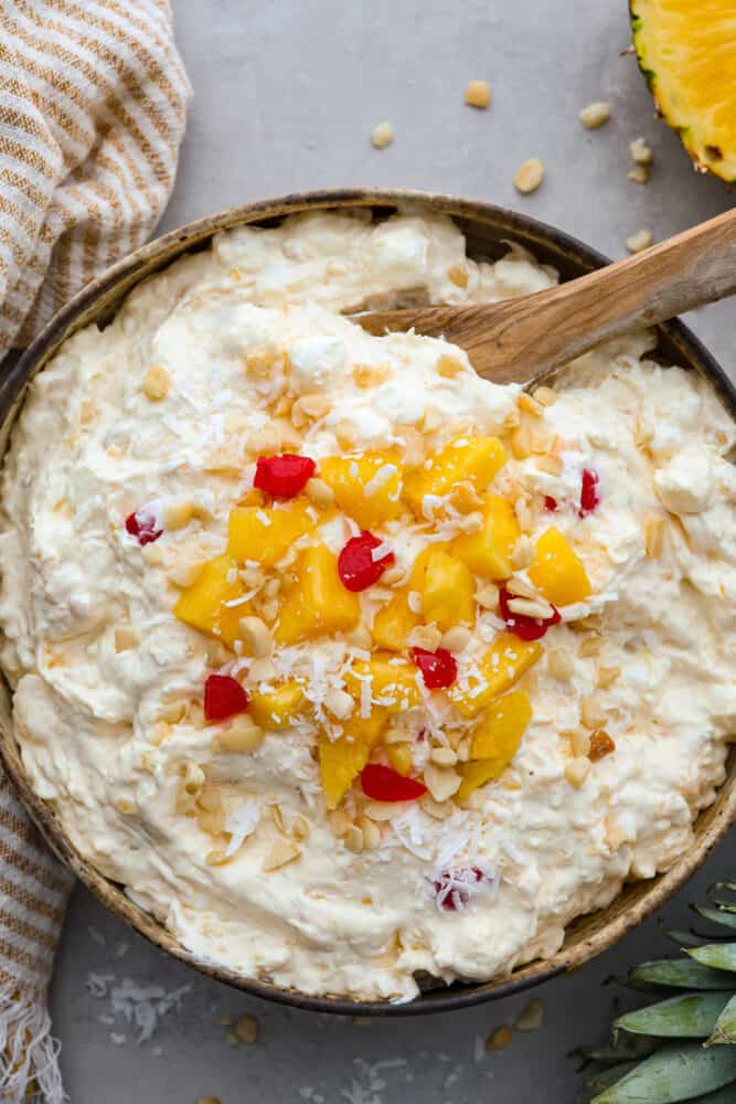 Get ready for this Pineapple Fluff to become your most requested recipe for potlucks! Similar to orange fluff, it's a delicious blend of pineapple chunks, coconut cream, marshmallows, and coconut flakes. It's seriously addicting and so easy to make! An overhead view of pineapple fluff.