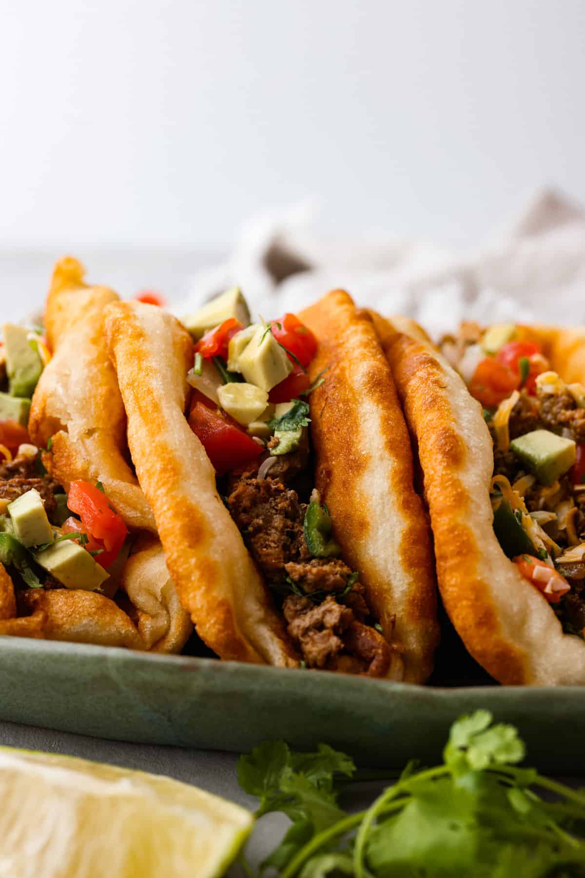 The perfect combination of airy, soft, and chewy, you NEED this homemade fry bread in your life! It's so versatile. You can enjoy it as-is, or use it as a canvas for all kinds of tasty sweet and savory creations. Fry bread filled with taco fixings.