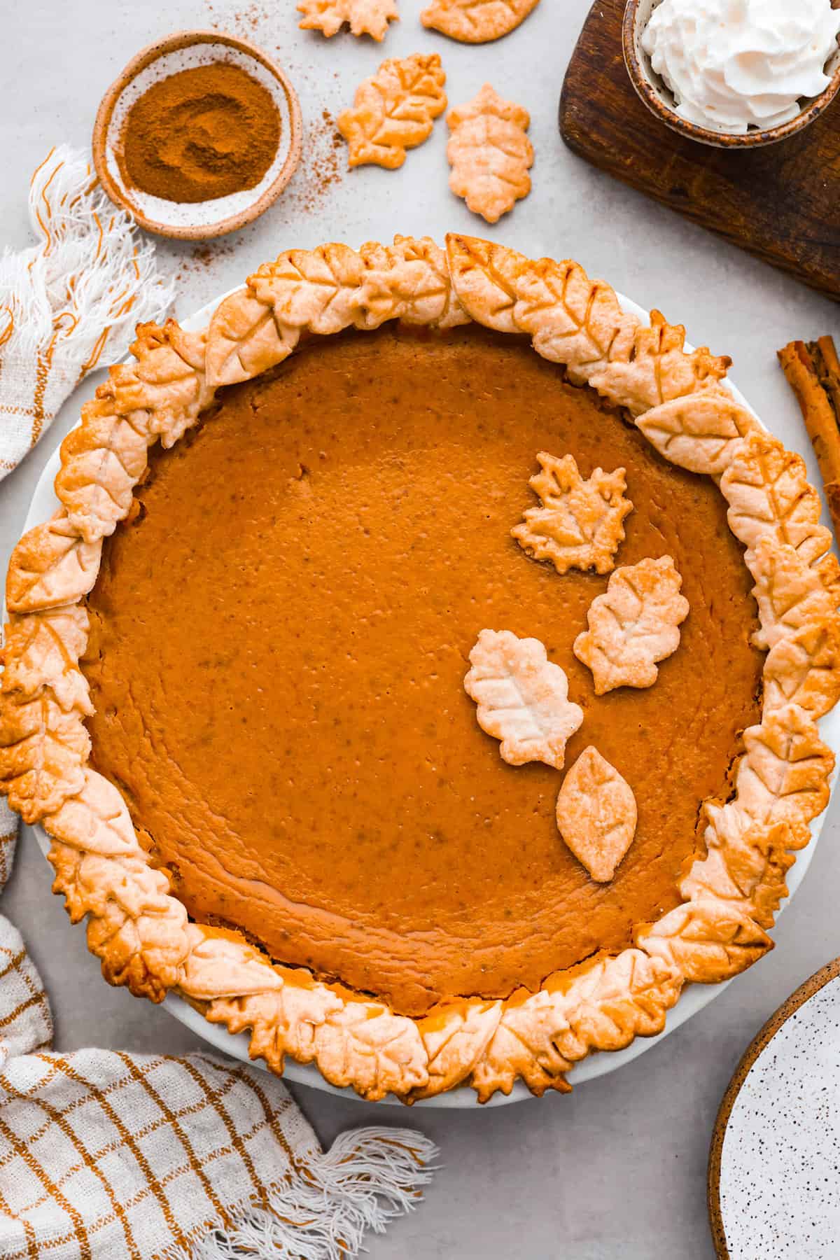 Grandma's famous pumpkin pie is smooth, thick, and creamy! A MUST for the holidays and the best when served with a big dollop of whipped cream on top! A baked pie, topped with pieces of crust that look like leaves.