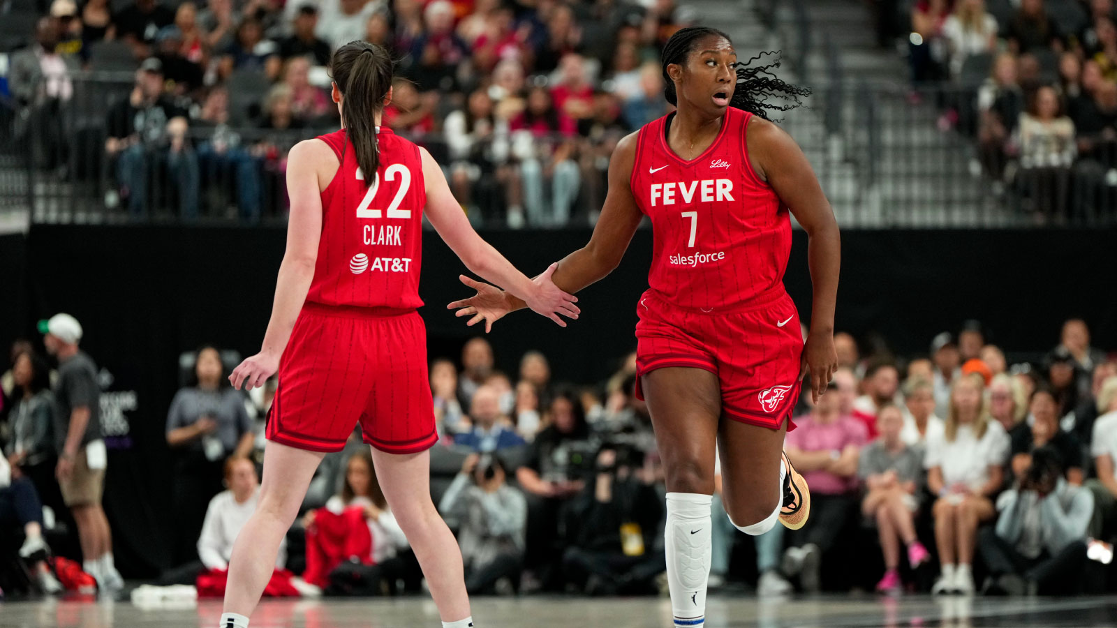 Indiana Fever center Aliyah Boston (7) celebrates with guard Caitlin Clark (22) after scoring against the Las Vegas Aces during the first half of a WNBA basketball game at T-Mobile Arena.