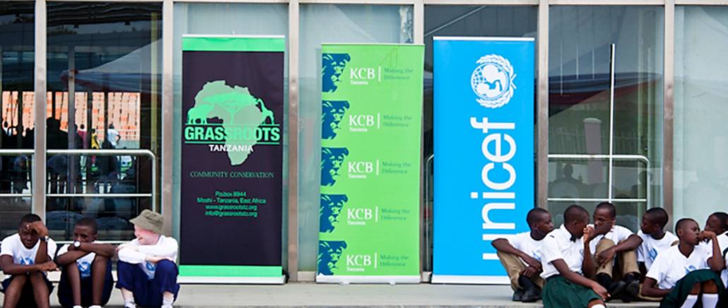 people sitting either side of roll up banners
