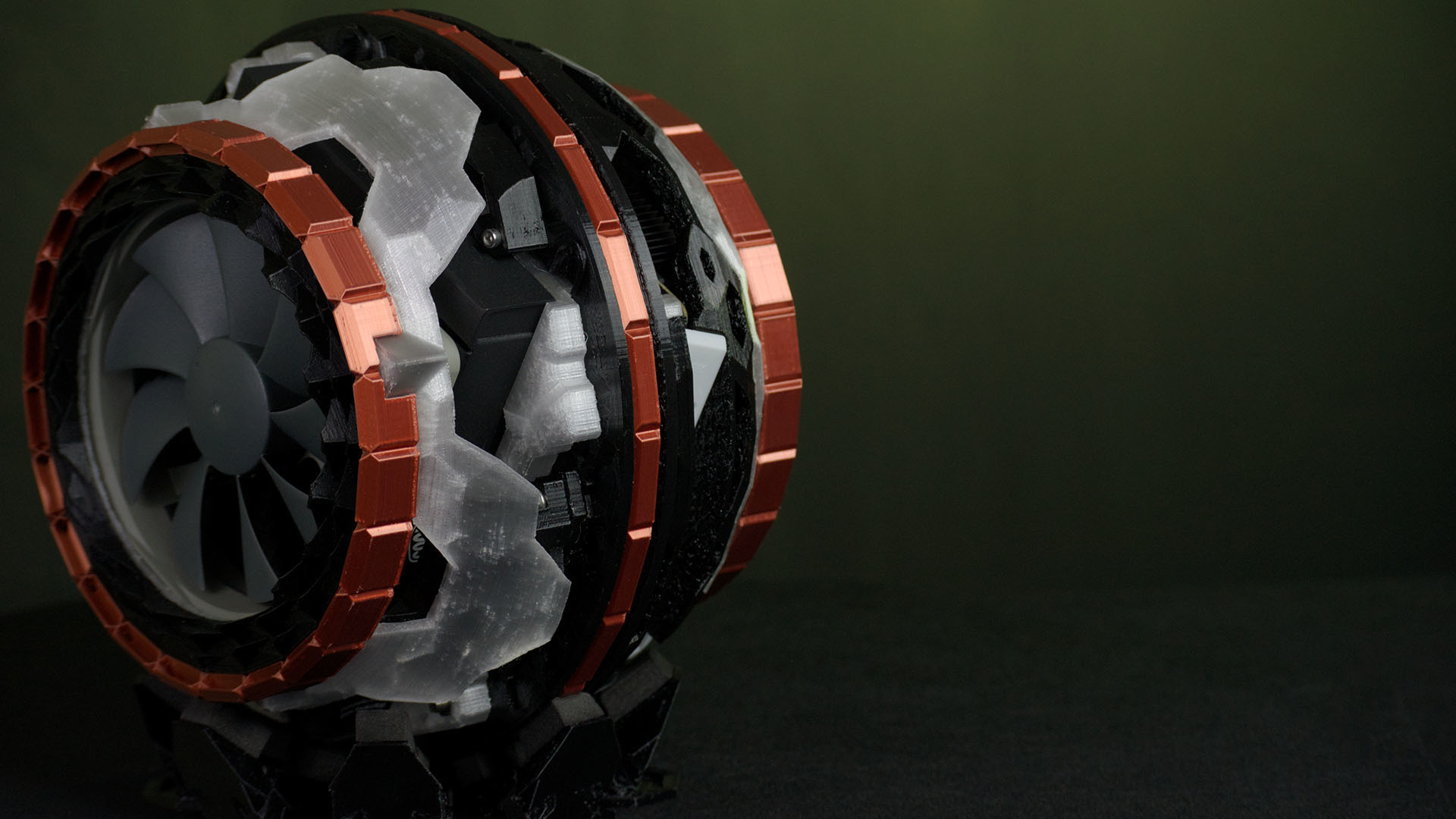 The white spherical 3D printed case with the outside case off showing the inside of the computer